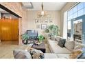 Cozy living room with exposed brick, large windows, comfortable sofa, and stylish décor at 2500 Walnut St # 201, Denver, CO 80205