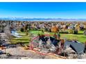 Aerial view of a gray two-story home near a golf course and mountains, encircled in red at 2765 Meadow Mountain Trl, Lafayette, CO 80026