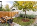 Cozy backyard featuring an outdoor dining set and a beautiful tree, perfect for relaxation at 3422 S Grant St, Englewood, CO 80113