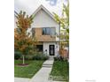 Modern two-story home featuring a well-maintained lawn, fresh landscaping, and a welcoming entryway at 3422 S Grant St, Englewood, CO 80113