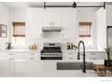 Clean, white kitchen design features a stainless steel oven, undermount sink, and stylish fixtures at 3422 S Grant St, Englewood, CO 80113