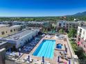 Rooftop pool and hot tub with lounge chairs and umbrellas offering city views at 3601 Arapahoe Ave # 304, Boulder, CO 80303