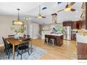 Bright kitchen with skylights, a large island, stainless steel appliances, and adjacent dining area at 400 Lois Dr, Louisville, CO 80027