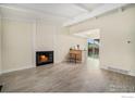 Bright living room with hardwood floors, fireplace, and bar for entertaining at 504 David Ct, Platteville, CO 80651