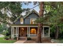 Beautiful two-story home with a covered front porch, stone accents, and mature trees at 505 Pine St, Boulder, CO 80302