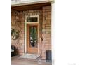 Close-up of the front door, featuring stone accents, a unique oval window, and classic charm at 505 Pine St, Boulder, CO 80302