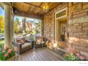 Inviting porch area showcasing comfortable seating, beautiful stone accents, and lovely garden touches at 505 Pine St, Boulder, CO 80302