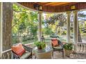 Cozy porch features wicker chairs, colorful pillows, and a charming view of the neighborhood at 505 Pine St, Boulder, CO 80302