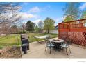 Outdoor living space with a patio, fire pit, grill, and hammock for relaxing and entertaining at 5452 Rustic Ave, Firestone, CO 80504