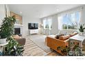 Bright living room featuring large windows, modern furniture, and stylish decor at 563 Green Mountain Dr, Erie, CO 80516