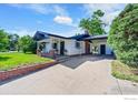 Residential home with a covered patio, attached carport, and concrete driveway at 707 E Emma St, Lafayette, CO 80026