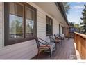 Charming covered porch with seating area, perfect for relaxing outdoors at 7240 Glacier View Rd, Longmont, CO 80503