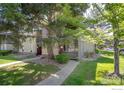 Charming exterior view of this townhouse, with a sidewalk leading to the front door and mature shade trees at 750 W Moorhead Cir # A, Boulder, CO 80305