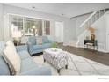 Cozy living room showcasing natural light, comfortable seating, contemporary decor, and stairway access at 750 W Moorhead Cir # A, Boulder, CO 80305