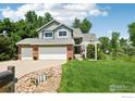 Charming two-story home with a well-manicured lawn, attached two-car garage, and inviting entryway at 7999 Centrebridge Dr, Niwot, CO 80503