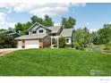Beautiful two-story house with a manicured lawn and charming white pergola at 7999 Centrebridge Dr, Niwot, CO 80503