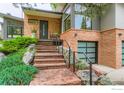 Stylish home with brick exterior, landscaped front yard, stone walkway, and two-car garage at 955 Jasmine Cir, Boulder, CO 80304