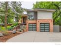 Beautiful home with brick and siding exterior, lush landscaping, and two-car garage at 955 Jasmine Cir, Boulder, CO 80304