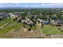 Aerial view of a property with a large yard, mature trees, and a white fence at 14652 Kalamath Ct, Westminster, CO 80023