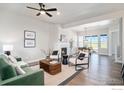 Bright living room features fireplace and open dining area at 1550 Harebell St, Berthoud, CO 80513