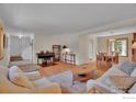 Open-concept living and dining area with hardwood floors, neutral decor, and ample natural light at 1590 Findlay Way, Boulder, CO 80305