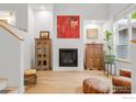 Spacious living room with a fireplace, hardwood floors, and modern decor at 179 Rendezvous Dr, Lafayette, CO 80026