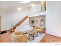 Spacious living room boasts high ceilings, hardwood floors, and a staircase leading to the second floor at 1945 Yank Ct, Golden, CO 80401