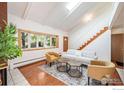 Sun-filled living room features hardwood floors, skylight, and a cozy seating area with modern furniture at 1945 Yank Ct, Golden, CO 80401