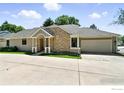 View of home exterior with attached garage, well manicured lawn, and concrete driveway at 203 Springs Dr, Louisville, CO 80027