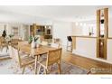 Spacious dining area featuring a wooden table, stylish chairs, and a large mirror at 2085 Alpine Dr, Boulder, CO 80304