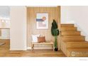 Welcoming foyer with modern bench, striking wall art, and elegant staircase at 2085 Alpine Dr, Boulder, CO 80304