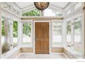 Sunlit entryway with transom windows, tile flooring, and a stylish chandelier for a welcoming ambiance at 2085 Alpine Dr, Boulder, CO 80304