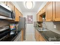 Efficient kitchen featuring granite countertops and stainless steel appliances at 252 N Pennsylvania St # 305, Denver, CO 80203