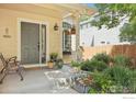 Inviting front porch with decorative plants and bench seating at 2608 E 132Nd Ave, Thornton, CO 80241
