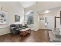 Bright living room with hardwood floors and vaulted ceilings at 2608 E 132Nd Ave, Thornton, CO 80241
