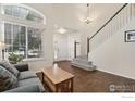 Cozy living room featuring hardwood floors and a staircase at 2608 E 132Nd Ave, Thornton, CO 80241