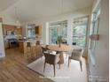 Cozy dining area with round table, modern chairs, large windows, and adjacent kitchen, perfect for Gathering meals at 322 Diamond Cir, Louisville, CO 80027