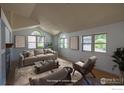 Bright living room featuring vaulted ceilings, large windows, comfortable seating, and stylish decor for a welcoming ambiance at 322 Diamond Cir, Louisville, CO 80027