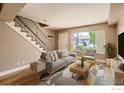 Bright living room with staircase, modern furniture, and large window at 4800 Osage Dr # 4A, Boulder, CO 80303