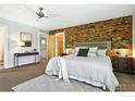 Serene main bedroom featuring a stone accent wall and modern furnishings at 5145 Denver St, Boulder, CO 80304