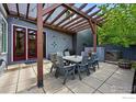 Relaxing outdoor patio with a dining set and overhead pergola for shade and entertaining at 5145 Denver St, Boulder, CO 80304