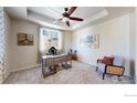 Bright bedroom with plush carpeting, decorative ceiling fan, and a large window providing ample natural light at 6358 Union Ave, Firestone, CO 80504