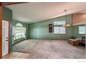 Spacious living room featuring high ceilings, lots of natural light and carpeted floors at 669 Timothy Dr, Longmont, CO 80503