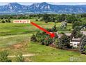 Stunning aerial view of 6838 Bugle Ct home with mountain views and lush green surroundings at 6838 Bugle Ct, Boulder, CO 80301