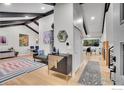 Bright and airy living room with hardwood floors, vaulted ceilings, and modern decor at 7146 Petursdale Ct, Boulder, CO 80301