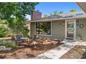 Close-up of the front exterior featuring a seating area and beautiful landscaping and a view of the front door at 7261 Mount Meeker Rd, Longmont, CO 80503
