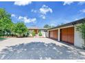 Beautiful ranch home with a light brick facade, a long driveway, and an attached two-car garage at 8753 Crimson Clover Ln, Longmont, CO 80503