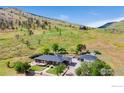 Beautiful ranch home featuring mature trees, circular deck and two-car garage with views of the hillside at 1125 Stone Canyon Rd, Longmont, CO 80503