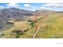 Aerial view of land boundary with grassy landscape and rolling hills under bright skies at 1125 Stone Canyon Rd, Longmont, CO 80503