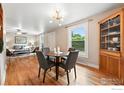 Open dining area showcases hardwood floors, modern lighting and flows into living room at 1202 9Th Ave, Longmont, CO 80501